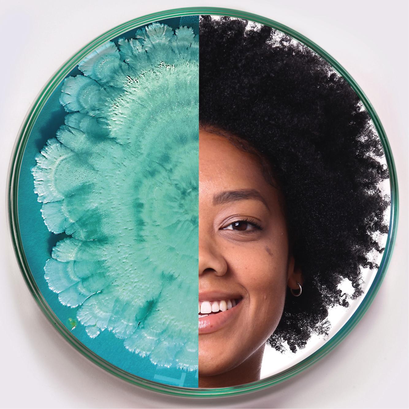 A circular image split in half; the left side features a teal microbial growth pattern, while the right side shows the smiling face of a person with afro-textured hair. The contrasting halves are visually striking.