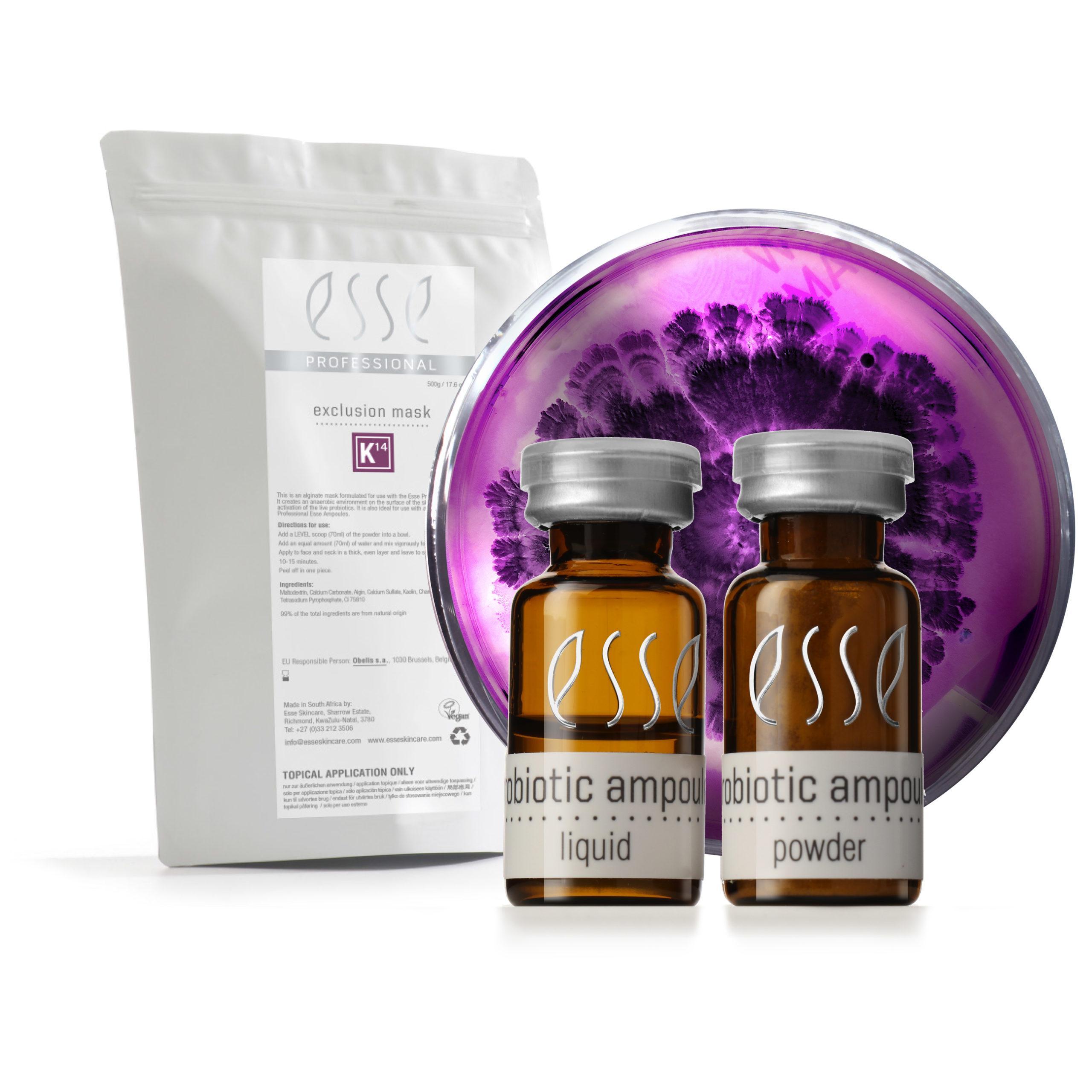 A product set featuring a white packet labeled "exclusion mask" beside two brown bottles labeled "probiotic ampoule" with "liquid" and "powder" respectively. Behind them is a petri dish with a purple culture. The brand name "Esse" is displayed on all items.