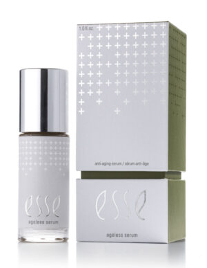 A bottle of Esse Ageless Serum with a silver cap sits beside its matching silver and green box, both featuring a minimalist design with small plus signs and the product name.