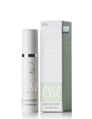 A compact, white bottle of Esse Spot Corrector is showcased beside its coordinating box. Both the bottle and the box boast minimalist designs, adorned with the brand name "esse" in an elegant, lowercase script and circular geometric elements. The box also includes additional text and a light green panel.