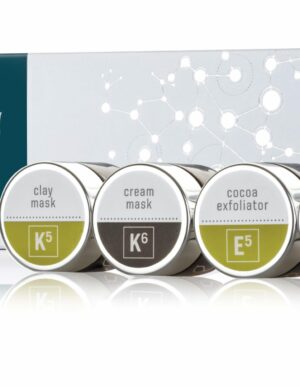 The Esse Limited Edition Festive Pamper Box is displayed along with its four skincare products: Clay Mask, Cream Mask, Cocoa Exfoliator, and Microderm Exfoliator. Each product comes in small round containers with distinct labels in various colors.