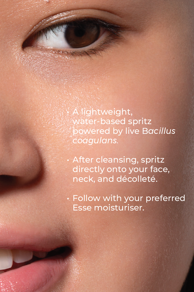 Close-up of a woman’s smooth skin. Overlaid text: "Live Probiotic Mist is a lightweight, water-based spritz with Bacillus coagulans. Apply after cleansing, then follow with Esse moisturizer.
