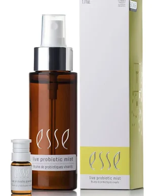 A brown bottle labeled "Live Probiotic Mist" stands beside a small vial and a white box with yellow accents, both also labeled "Live Probiotic Mist.