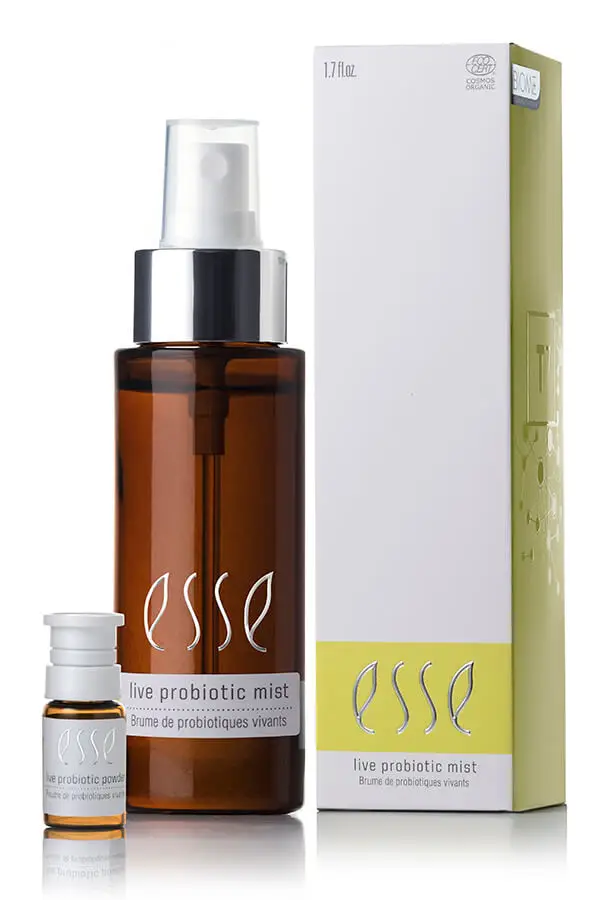 A brown bottle labeled "Live Probiotic Mist" stands beside a small vial and a white box with yellow accents, both also labeled "Live Probiotic Mist.