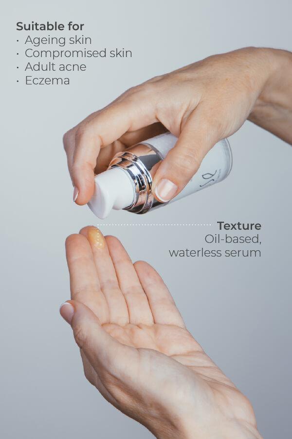 A hand pumps a small amount of Esse Probiotic Serum, an oil-based, waterless serum, onto the palm. Suitable for ageing skin, compromised skin, adult acne, and eczema.