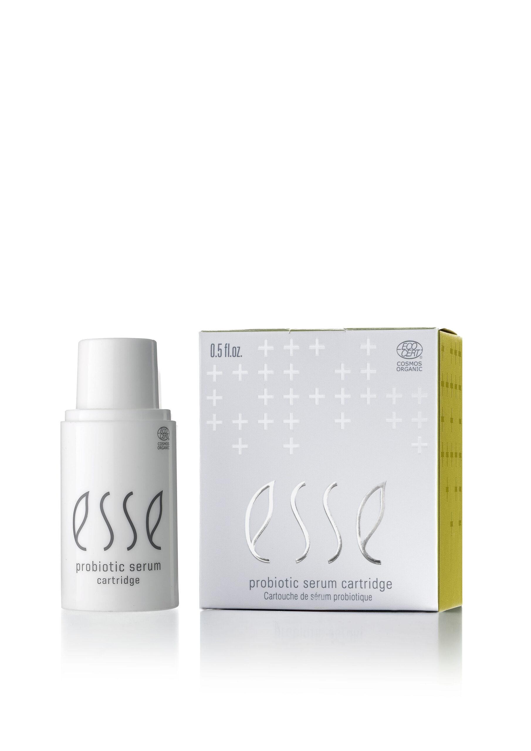 A white bottle of Esse Probiotic Serum stands beside its matching white and yellow box, both displaying the brand name in gray text.